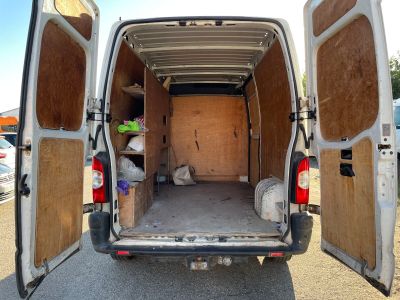 the back of a van with the doors open and the back door open