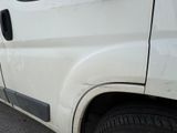 a white van that is parked on the side of the road