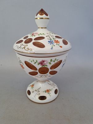 a white bowl with a brown and white design on it