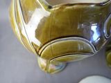 a close up of a vase with a cat face on it