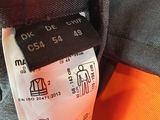 a close up of the label on the back of an orange jacket