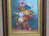 a painting of flowers in a vase hanging on a wall