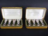 a pair of silver spoons in a gold case