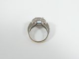 a close up of a silver ring with a blue stone in the center