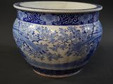 a blue and white vase with a bird design on it