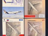 three model airplanes sitting on top of a table next to each other