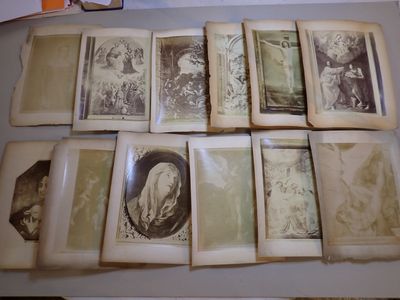 several old photos of women and children are displayed on a table