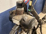 a motorcycle that is parked next to a blue wall