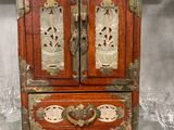 a small wooden cabinet with a mirror on top of it