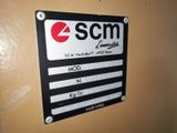 a picture of a sign on a wall that says scm