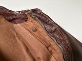 brown leather bag with zippers and zippered closure on it