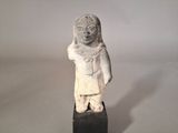 statue of a woman in a white dress on a black block