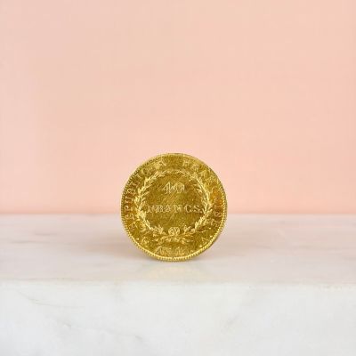an image of a gold coin sitting on top of a marble counter