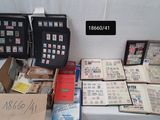 a lot of stamps on a table with a lot of books