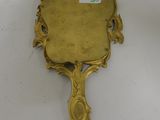 an antique brass mirror with a handle and a handle that has been painted gold