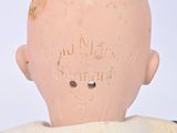 a clay head on a mannequin with writing on it