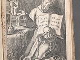 an old book with a drawing of a man holding a skull