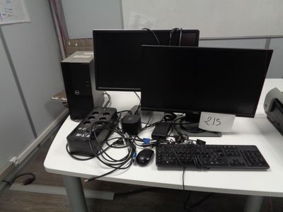 a desk with a computer, keyboard, mouse, and monitor on it