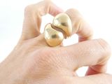 a person holding a gold ring in their hand