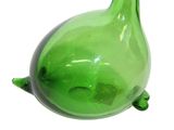 a green glass vase that has a turtle on it