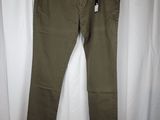 a pair of olive green pants hanging on a white curtain