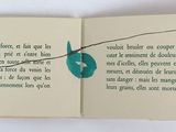 an open book with a picture of a leaf on it