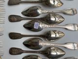 a lot of silver spoons and forks on a table
