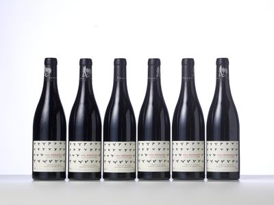six bottles of wine lined up in a row on a table
