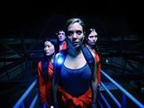 a woman in a red and blue outfit standing in front of a group of people