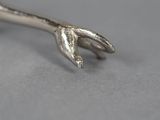 a silver spoon with a fork sticking out of it