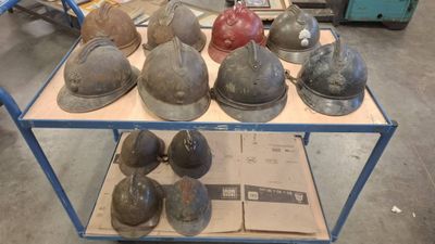 many helmets sitting on a cart in a warehouse