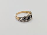 a close up of a gold ring with a blue stone