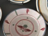 four plates with designs on them on a table
