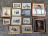 many framed pictures on the floor of this room