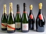 six bottles of champagne are lined up in a row on a table