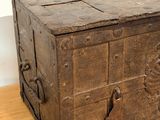 an old wooden chest with a metal latch on it