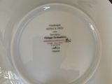 a person holding a white plate with a picture on it