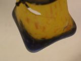 a close up of a yellow object on a white surface