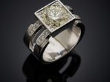 a close up of a diamond ring on a black surface