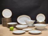 a lot of plates and bowls on the table