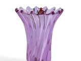 a purple glass vase with a butterfly on top of it