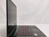 a black laptop with a red keyboard sitting on a white surface