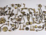 a lot of antique brass door handles and knobs