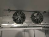two fans that are attached to a wall
