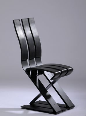 an image of a black chair with a metal frame on it