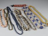 a lot of necklaces that are on a table