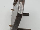 a metal object that is sitting on a white surface