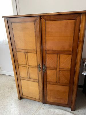 a wooden cabinet with a door on top of it