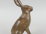 a bronze statue of a rabbit sitting on its hind legs