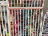 many different colors of paint on the shelves in the store